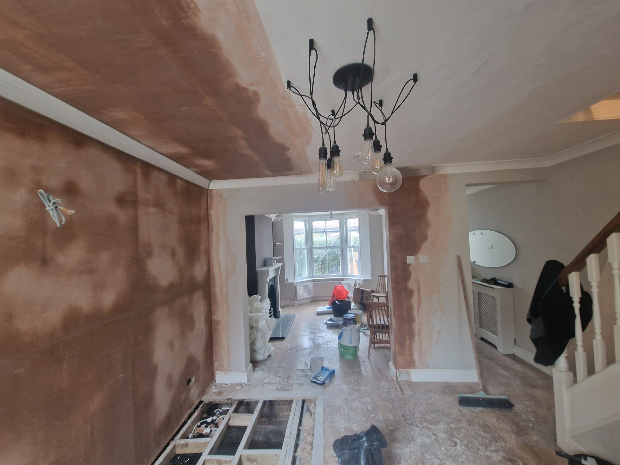 Through lounge with newly plastered walls and ceiling
